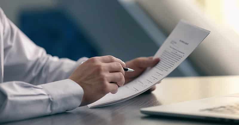 Business man reviewing landscape contract