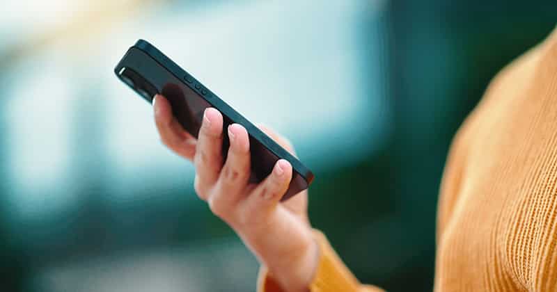 Individuals hands holding smart phone
