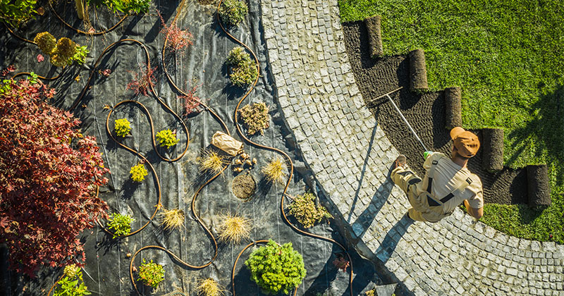 an aerial shot of a person doing landscaping work