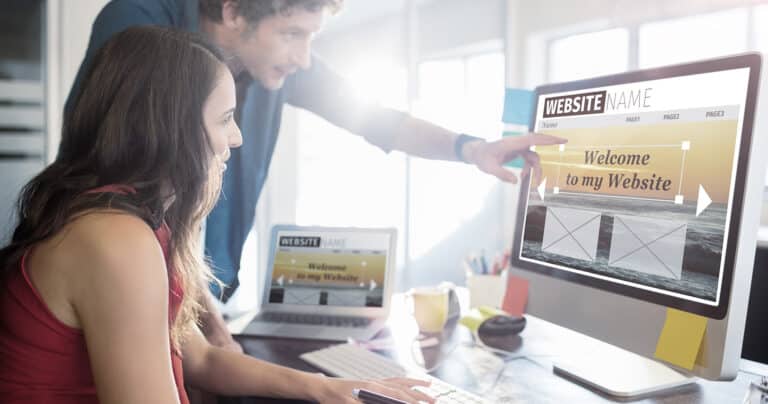 couple designing a website on a computer