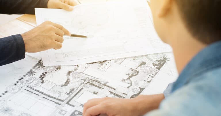 two-men-planning-landscape-project-on-paper
